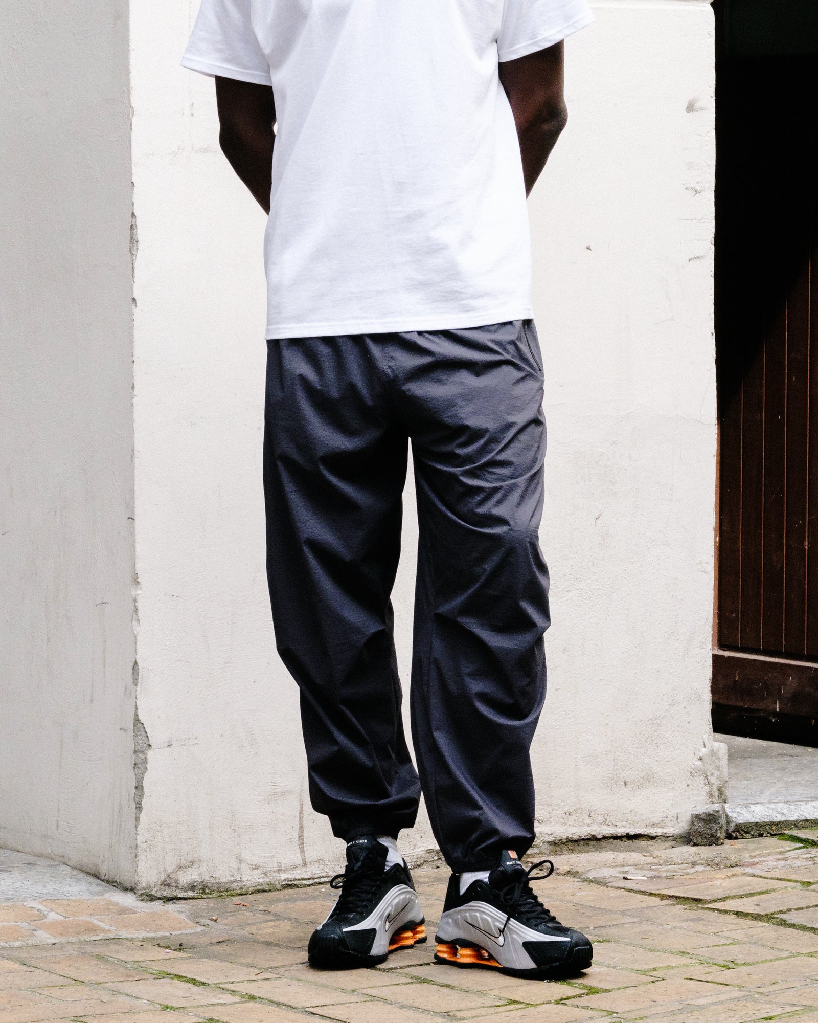 The North Face M TNF RB Wind Pant Obsidian Sweat & Track Pants NF0A8EFV0SA On Model Front View | Overkill