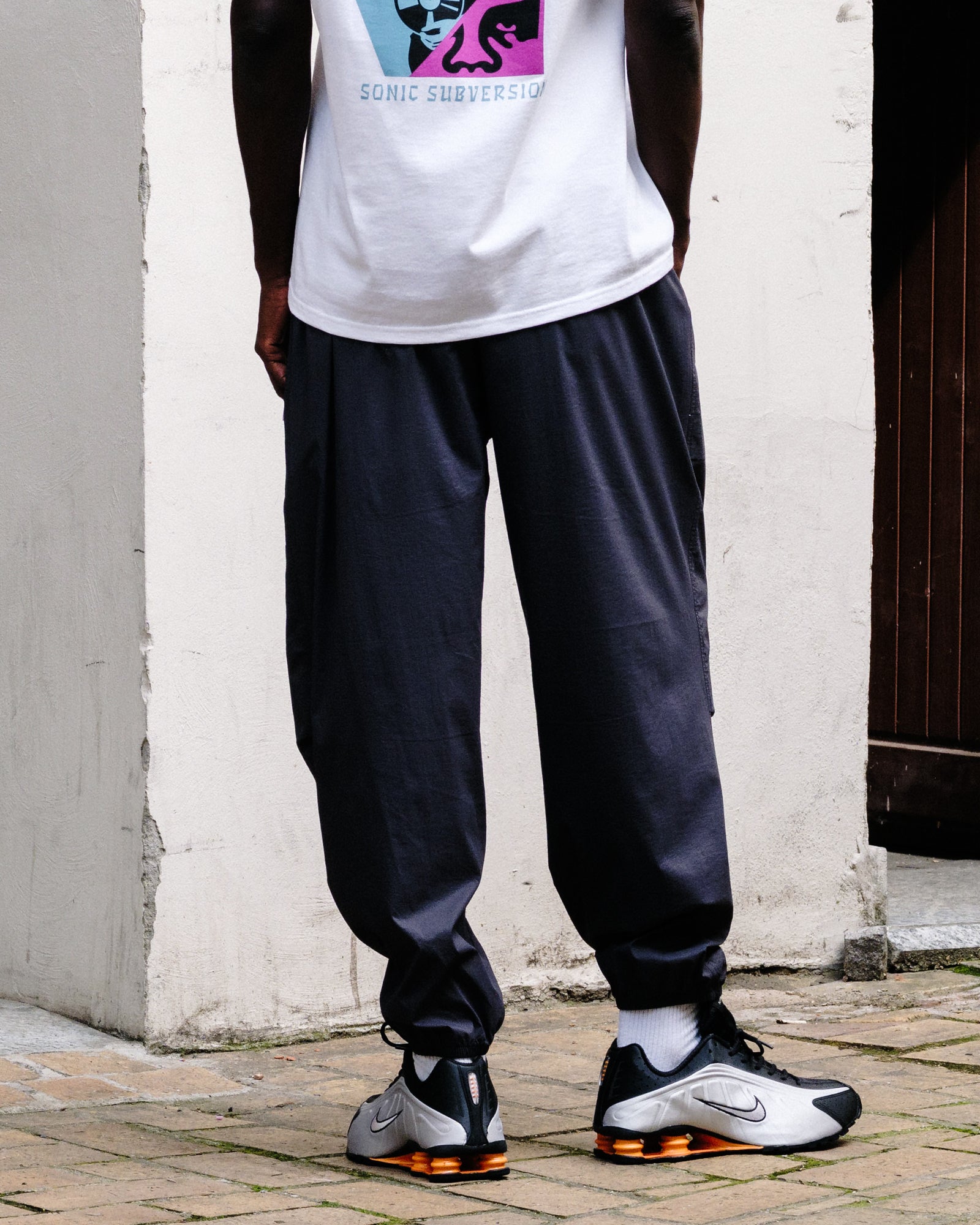 The North Face M TNF RB Wind Pant Obsidian Sweat & Track Pants NF0A8EFV0SA On Model Back View | Overkill