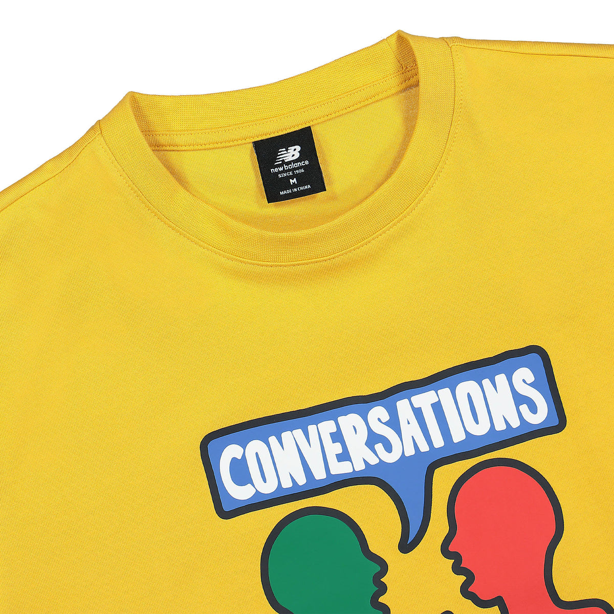 New Balance Conversations Amongst Us Tee Yellow T-Shirts Close-up | Overkill