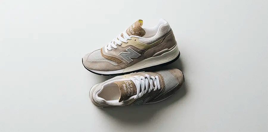 A pair of New Balance 997 shoes, proudly made in the USA, showcasing a stylish blend of suede and mesh.