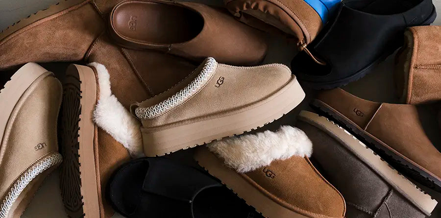 A variety of UGG slip-on shoes are scattered, showcasing different shades of brown, beige, and black. Some feature plush linings, evoking comfort and warmth.