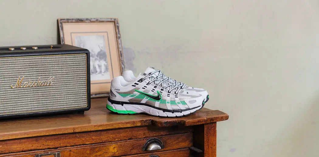 A stylish man rocking Nike P-6000 sneakers, black pants, and white socks. Fashion on point!