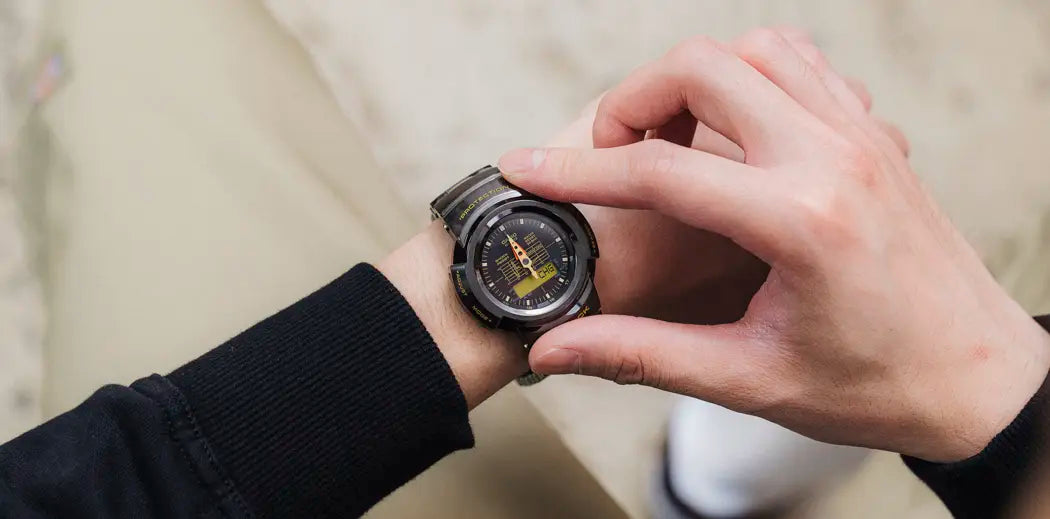  A man watching the time at his watch, showcasing stylish jewelry for men.