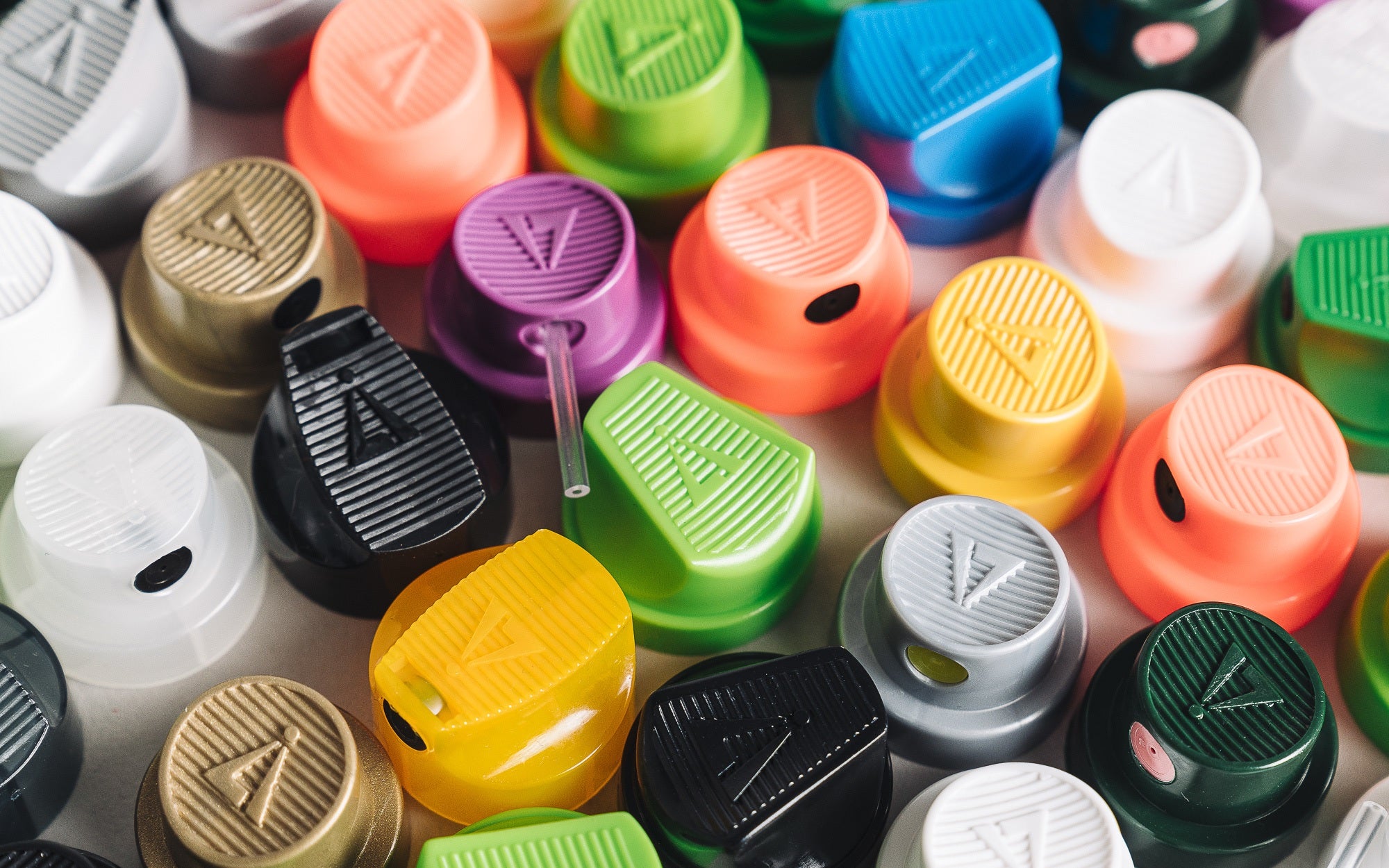  A vibrant mix of colorful caps of graffiti caps