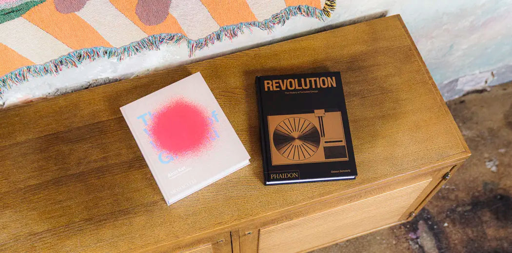 Wooden dresser with a stack of books by Phaidon.