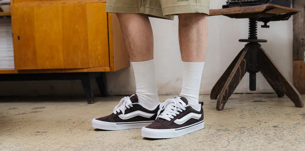  Stylish black Vans sneakers with white sole, perfect for casual wear or skating.