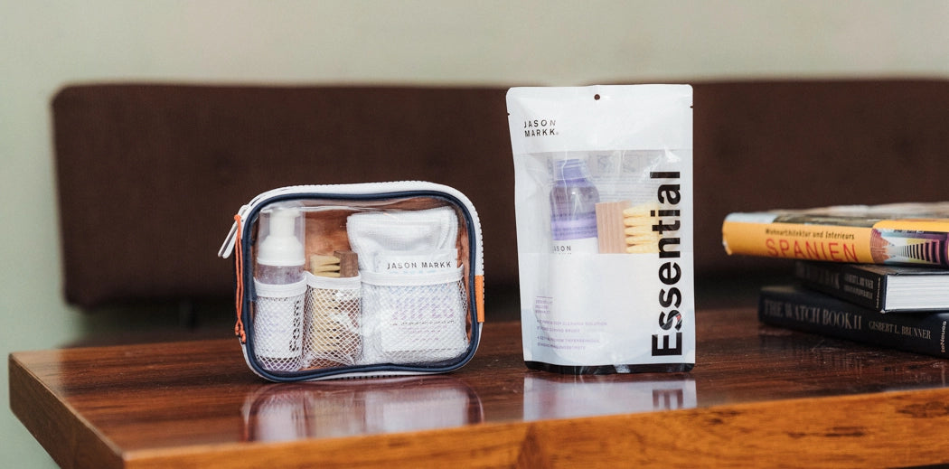 Sneaker care products on display, placed on a wooden table.