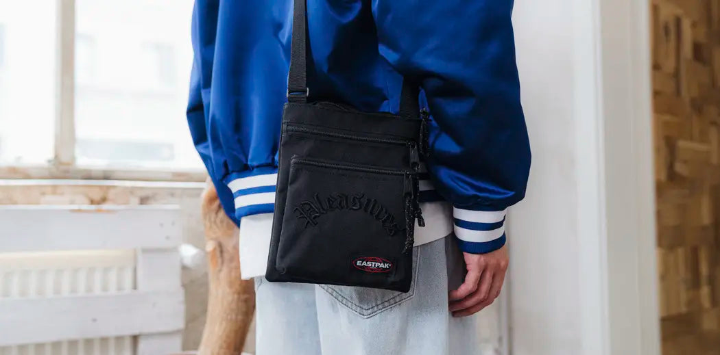 A man wearing a black bucket hat by Eastpak.