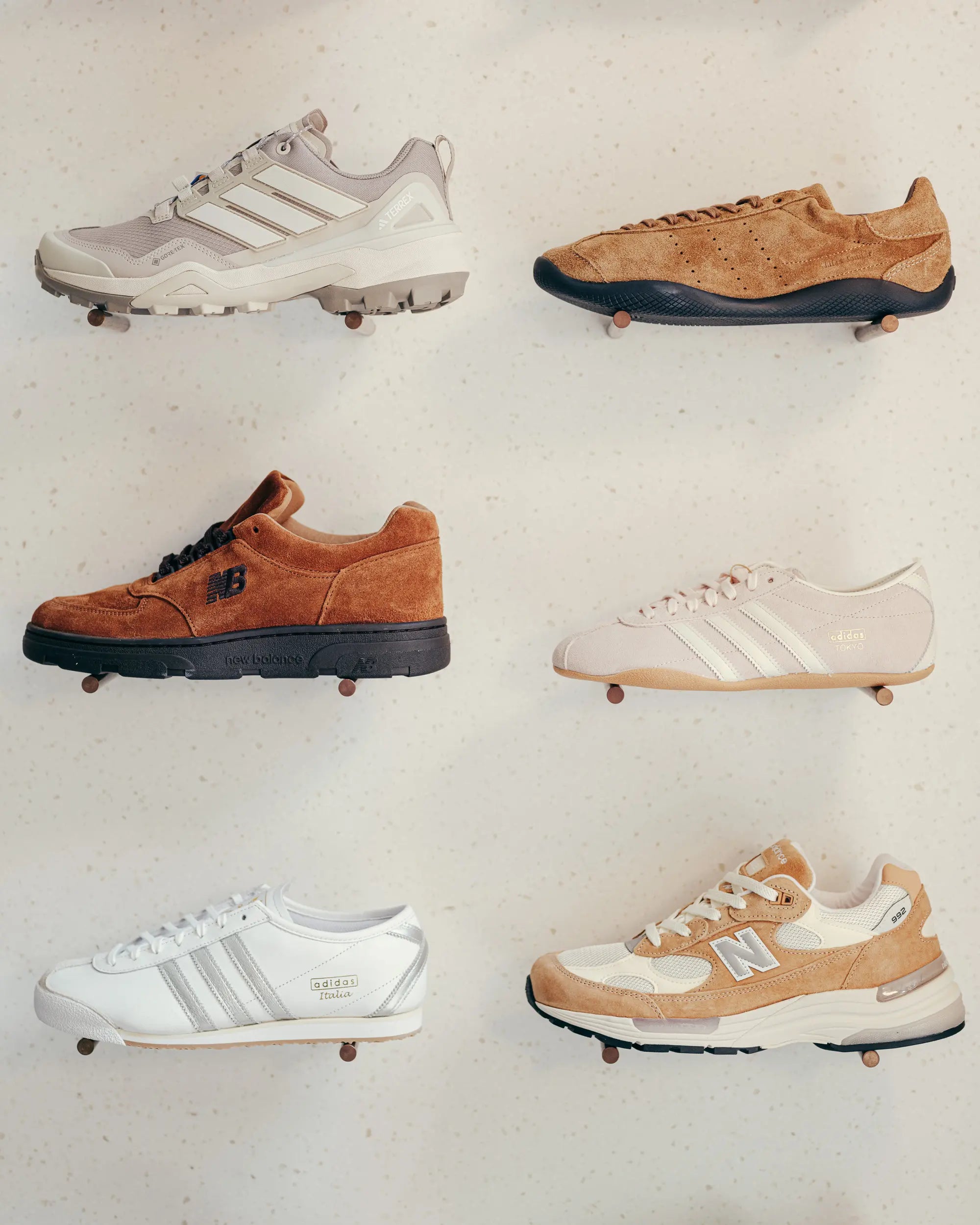 Six autumn sneakers 2025 floating against a speckled background. Styles vary from sporty to casual, in shades of beige, brown, and white with diverse textures.