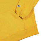 Puma Wmns Downtown Graphic Hoodie Mineral Yellow Hoodies Detailfoto | Overkill