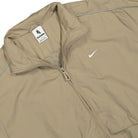 Nike Solo Swoosh Woven Track Jacket Khaki / White Track Jackets Close-up | Overkill