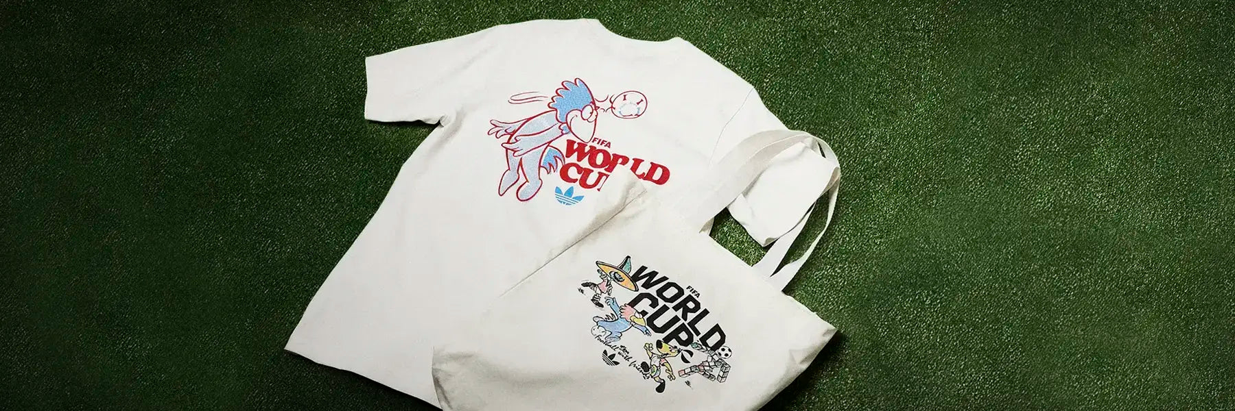 T-shirt and tote bag featuring colorful cartoon designs and "World Cup" text, set on vibrant green turf, convey a playful and sporty vibe.