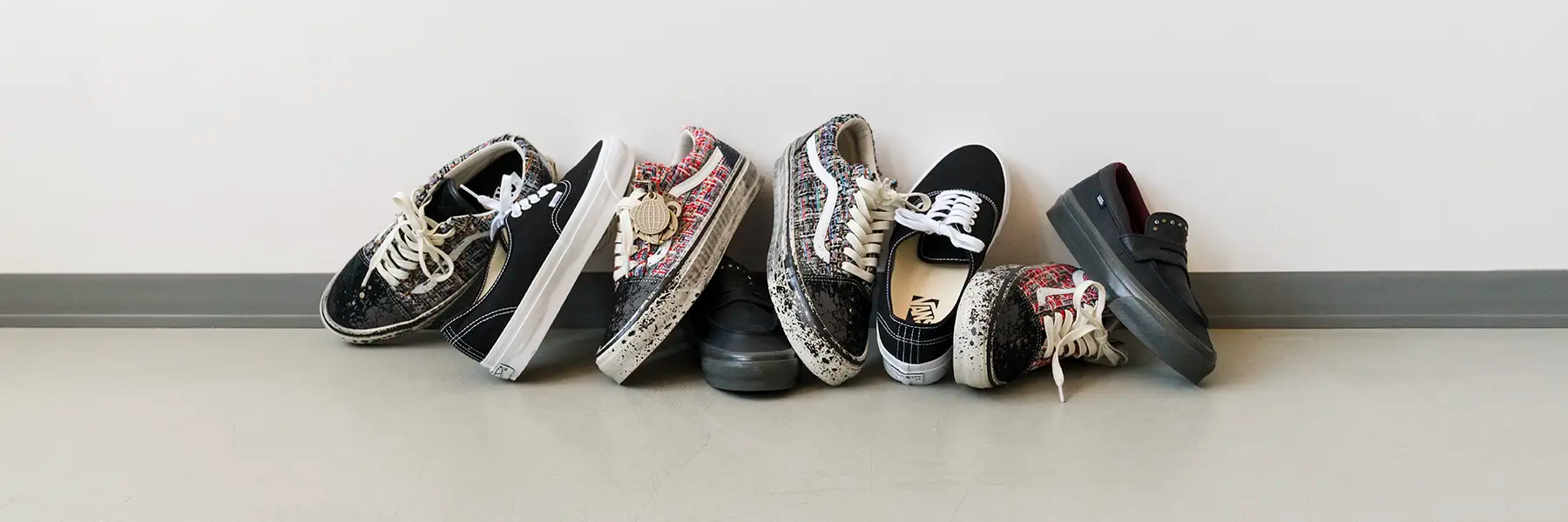 Multiple Vans sneakers laid on the floor